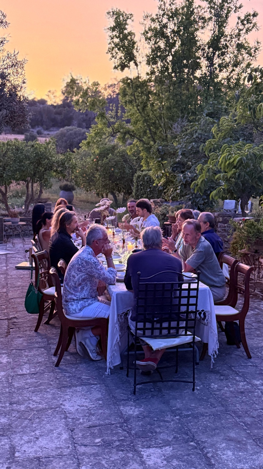 Guests enjoying a private dinner together at sunset