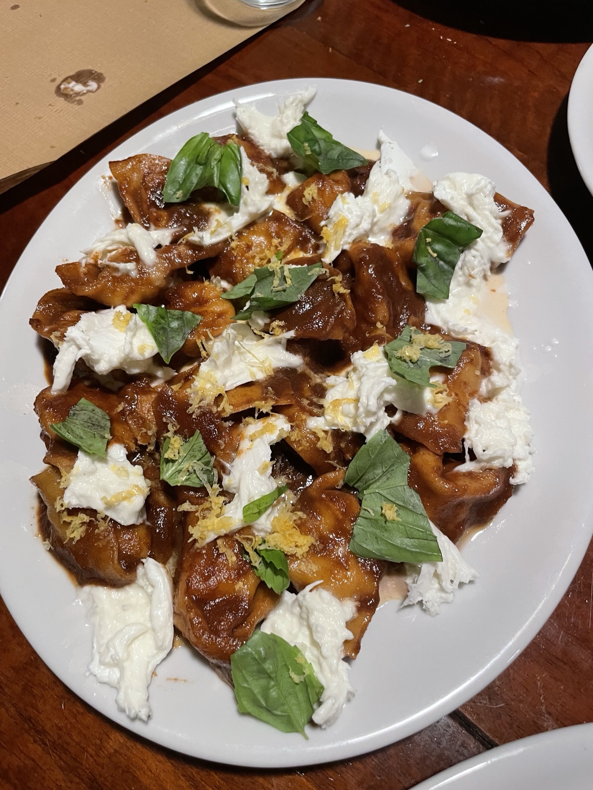 Fresh pasta with burrata, basil and lemon