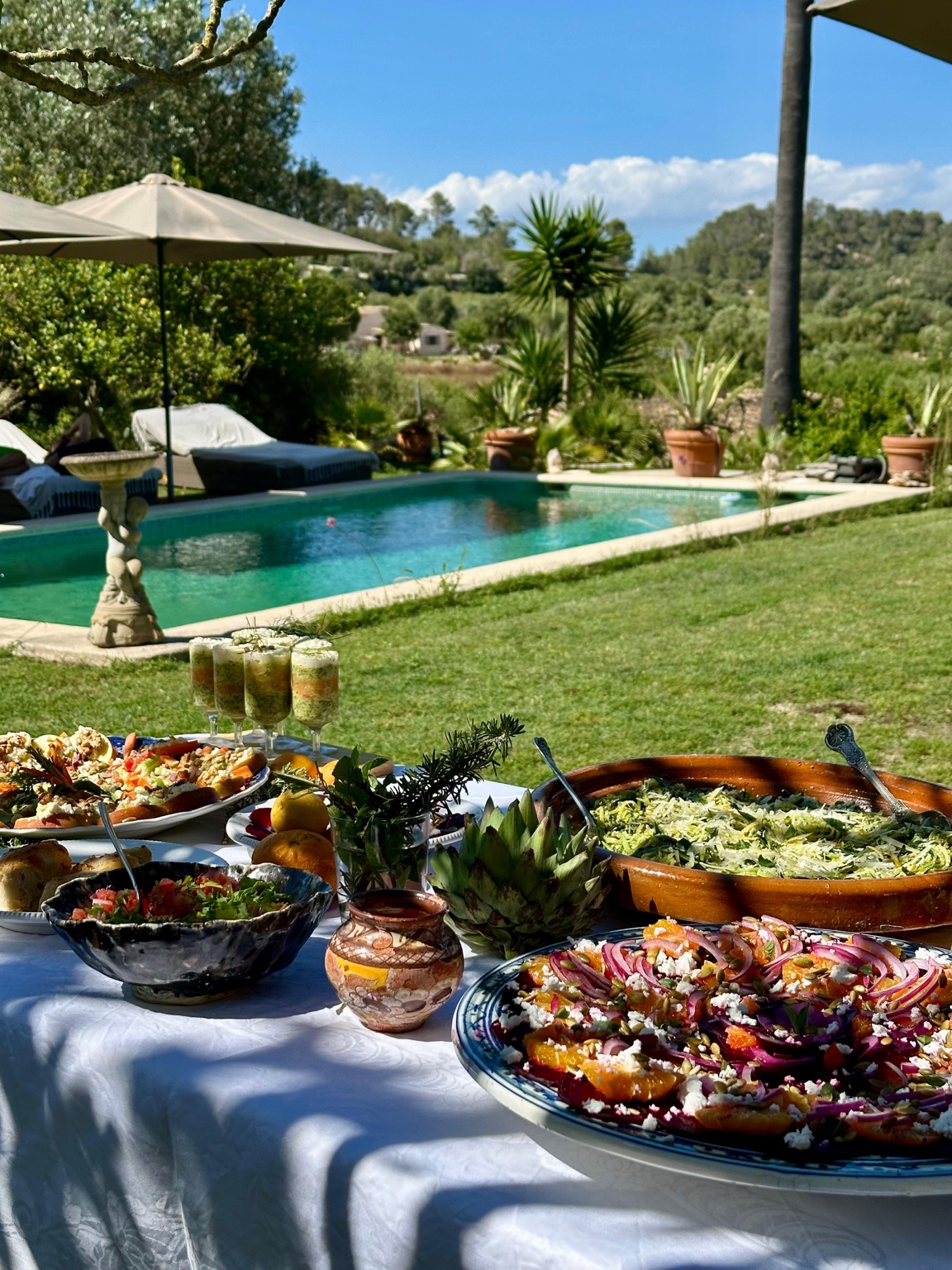 Private lunch by the pool with a generous Mediterranean spread